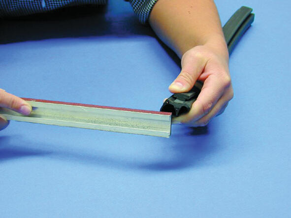 6. Grind the edge of the list so it gets as rectangular as possible. Then buff around the whole strap from the end and 12 mm in.