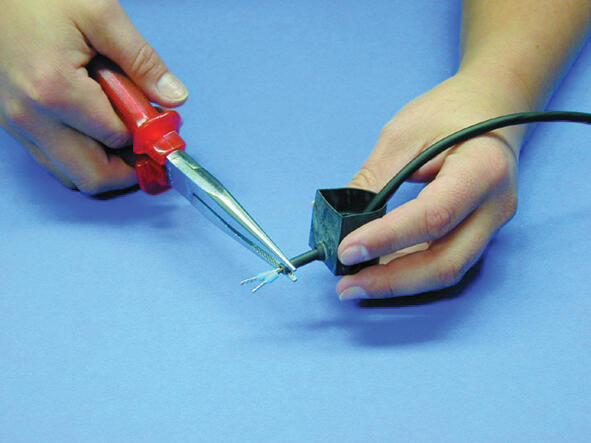 9. Pull the tong through the hole and pull the cable through.